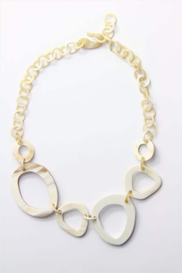 Collier en corne beige-blanc avec 1 élément laqué blanc. Eléments du centre environ 4 à 5 cm, éléments de la « chaîne » environ 12 mm de diamètre. Longueur ajustable jusqu’à 49 cm. Orligne Genève LQP12 SOY-1-1